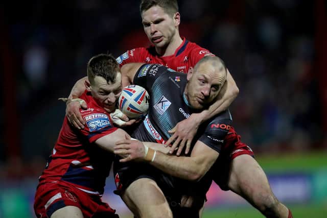 Tough night: St Helens' James Roby (centre) is tackled by Hull KR's Frank Halton (left) and Matt Parcell. Picture: Simon Marper/PA Wire.