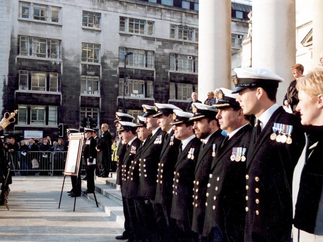 Commissioned Officers from the Ark Royal in full ceremonial dress decorated with medals. Officers are lined up outside the Civic Hall.