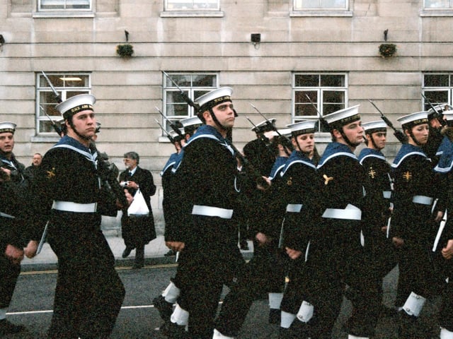 Members of the Ark Royal Guard as they perform a March Past. The March Past was taken by The Lord Mayor and Captain Nance OBE. The Ark Royal Guard wear white belts and gaiters and carry rifle mounted bayonets.