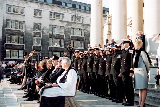 The Civic Hall steps where special guests attending the Ark Royal parade are positioned. Towards the left is the Mace Bearer for the City of Leeds, John Wilson, in full ceremonial dress carrying the Mace. Seated guests include the Chaplain of the Ark Royal on the right.