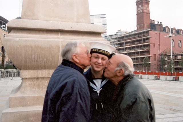 Pct Zoe Beer of the company of the Ark Royal is kissed on the cheek by two Navy veterans. Pictured is Derek Vickers (left) with Derrick Nunn.