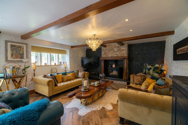 An inglenook fireplace and contemporary style wall add to the character of the beamed lounge.