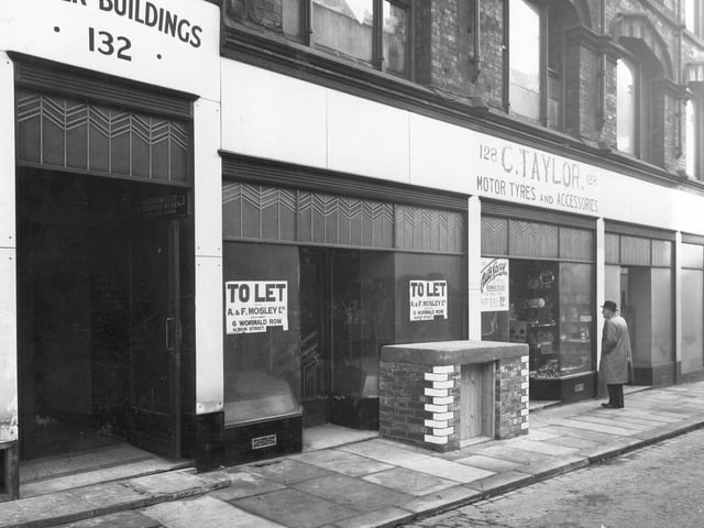 Empty shops on Albion Street in December 1940. Pictured, from left, is Tower Buildings, then C. Taylor, Motor Tyres and Accessories. The purpose of the small brick structure with wooden door is unknown