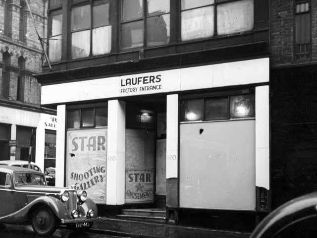 The factory entrance of Laufers, wholesale clothiers on Albion Street in November 1946. The shop window has an advertisement for Star Amusements and Shooting Gallery, further along. A Jaguar car is parked outside. St Ann Street is on the left.