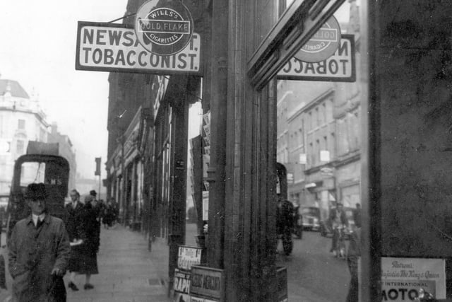 Albion Street showing Jowett and Sowry, Swift Bros. debt collectors, tobacconist with sign for Gold Flake, Players and newspaper placard outside. The photo dates back to September 1937.