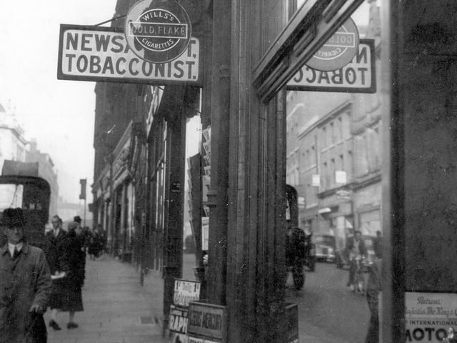 Albion Street showing Jowett and Sowry, Swift Bros. debt collectors, tobacconist with sign for Gold Flake, Players and newspaper placard outside. The photo dates back to September 1937.
