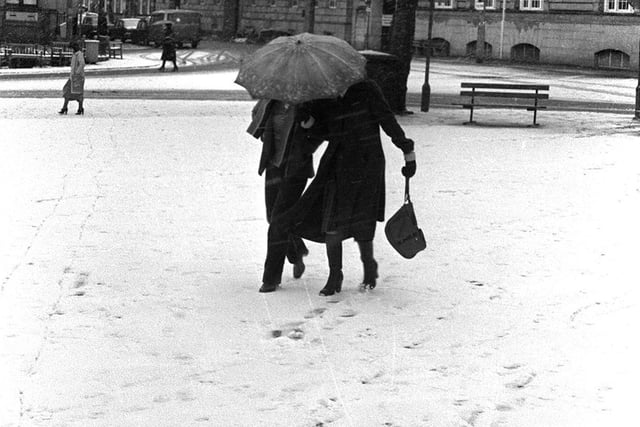 In 1978 shoppers struggle across the flag market in Preston after an early December snowfall