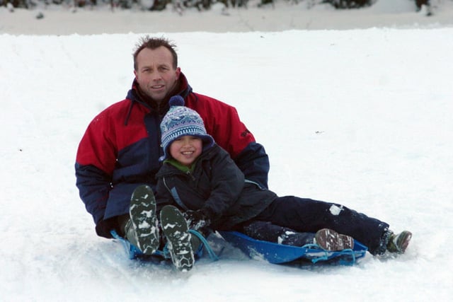 In another picture from 2010 Martin Greenbank and Louis of Chorley enjoy a spot of sledging in Chorley's Astley Park