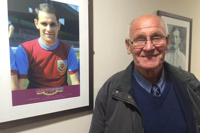 Jimmy Robson poses next to a photograph of himself from his Burley playing days