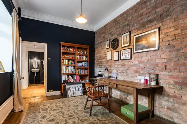 There is also a handy study space on the ground floor which features rustic wood tones and an exposed brick wall.