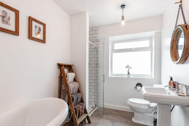 The family bathroom is a large space and very modern, with a standalone bath and standalone shower.