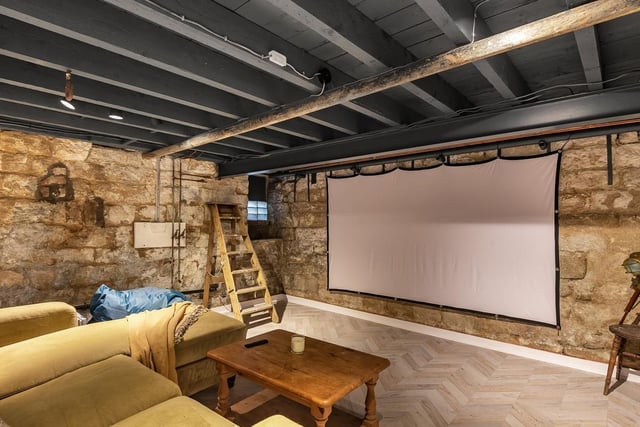 On the lower ground floor is a storage space but also a surprise addition with a home cinema.
