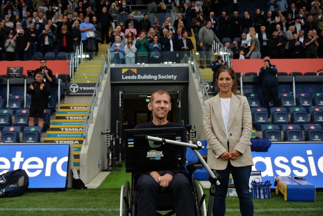 Leeds Rhinos legend Rob Burrow is helped toward the pitch by wife Lindsey to watch his former club take on Huddersfield Giants in August. Picture: Jonathan Gawthorpe.