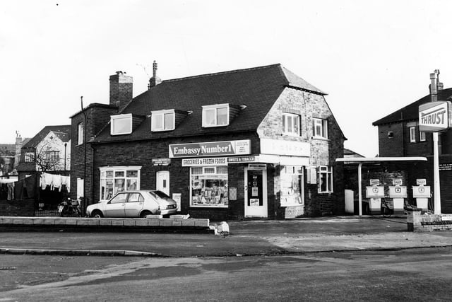 The crossroads of Harrogate Road and Victoria Avenue with Bayton Lane and Yeadon High Street in November 1979. Pictured in the centre is a shop selling groceries and frozen foods, sweets and tobacco. There are three petrol pumps. The proprietor is Parish & Son, Yeadon Ltd.