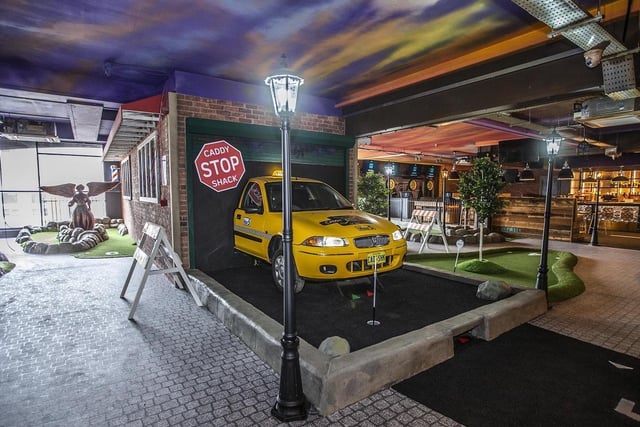 Caddy Shack is themed like the Lower East Side of New York City, complete with a yellow cab and Central Park streetlights