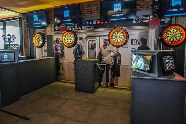 Try not to hit the commuters on the subway when playing darts at Caddy Shack!