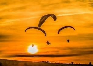 Firle, Lewes, East Sussex, UK ..4th January 2019 ..Paragliding in the Northerly breeze as the sun goes down over the South Downs. David Burr SUS-200807-125511001