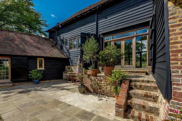 Great Thorndean Barn is an timber-clad family home offering flexible accommodation arranged over two floors.