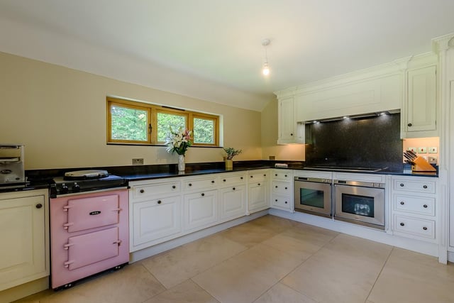 The kitchen is well appointed, fitted with a Smallbone kitchen, a large central island and breakfast bar, granite worktops, a single Aga..