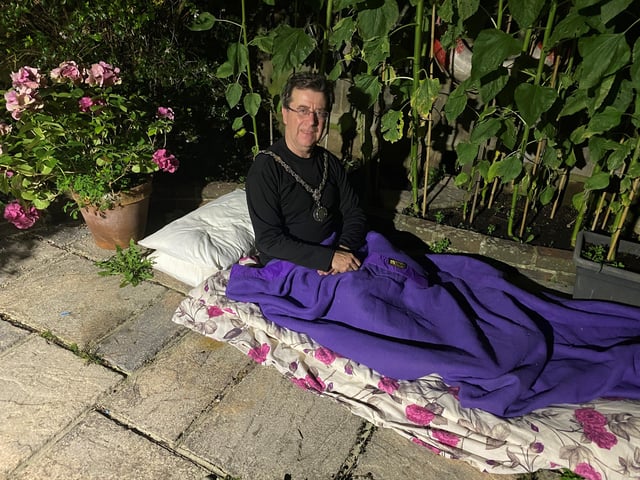 Adur District Council chairman Andy McGregor in a sleeping bag on his patio