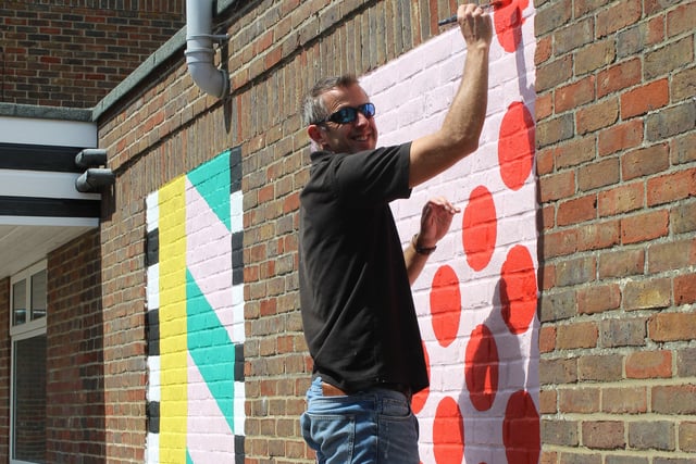 Head teacher Simon Liley painting spots on the wall