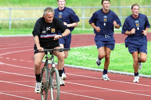 Denis Casey takes to two wheels as he leads a pre-season running session on the old athletics tracks at Sixfields