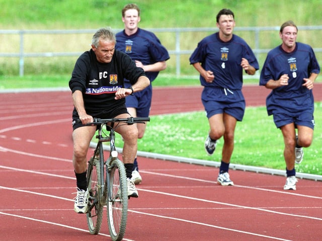 Denis Casey takes to two wheels as he leads a pre-season running session on the old athletics tracks at Sixfields