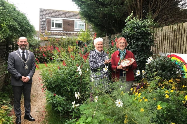 Valerie Narayanaswamy and Jacqueline Patrick with Rustington Parish Council chairman Jon Street at The Hidden Twitten, winner of best community garden