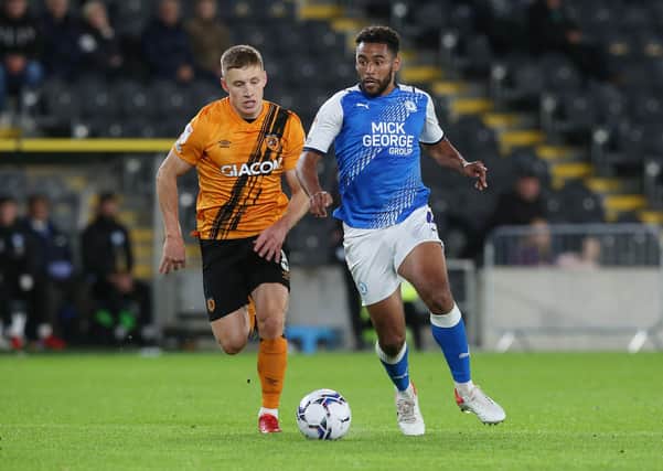 Nathan Thompson of Peterborough United in action with Greg Docherty of Hull City. Photo: Joe Dent/theposh.com.