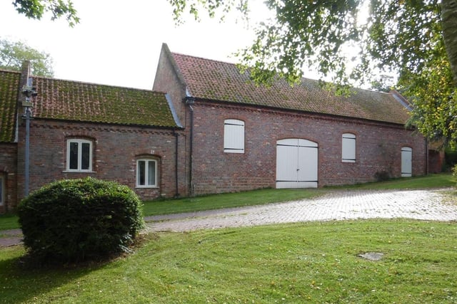 The Grade II listed barn and part of one of the converted cottages.