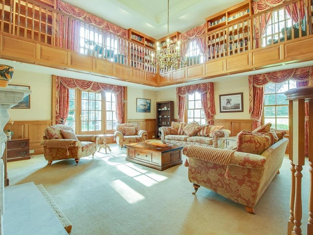 The double-height drawing room with galleried landing.