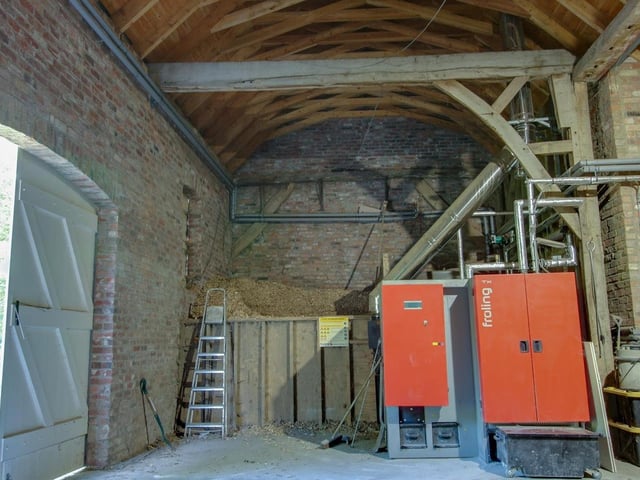 Inside the Grade II listed barn, which houses a Froling Bio-mass boiler together with controls, storage area for wood chippings.