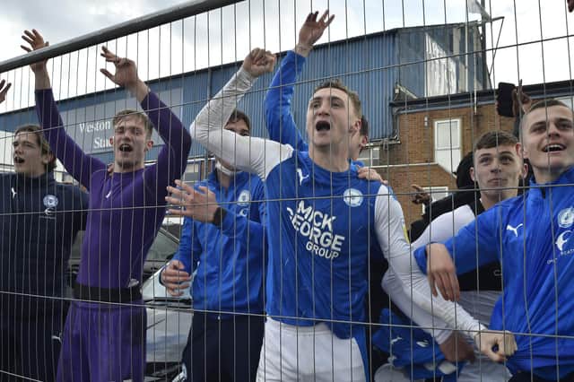 Posh players celebrate promotion after the draw against Lincoln. Photo: David Lowndes.
