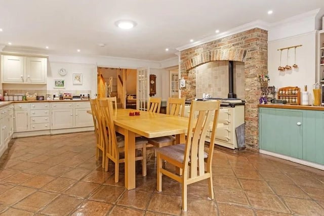 The large Shaker-style kitchen can easily accommodate a central dining area. It also has an Aga and an exposed brick chimney breast. The French doors make it easy to enjoy al fresco meals. Picture: Hamptons - Haywards Heath Sales.