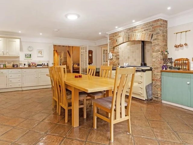 The large Shaker-style kitchen can easily accommodate a central dining area. It also has an Aga and an exposed brick chimney breast. The French doors make it easy to enjoy al fresco meals. Picture: Hamptons - Haywards Heath Sales.