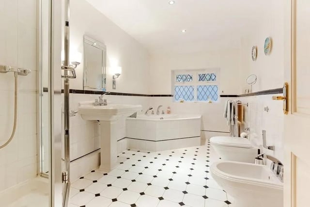 A large family bathroom has a corner bath and shower cubicle. Picture: Hamptons - Haywards Heath Sales.
