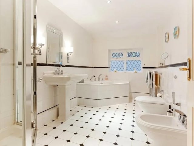 A large family bathroom has a corner bath and shower cubicle. Picture: Hamptons - Haywards Heath Sales.