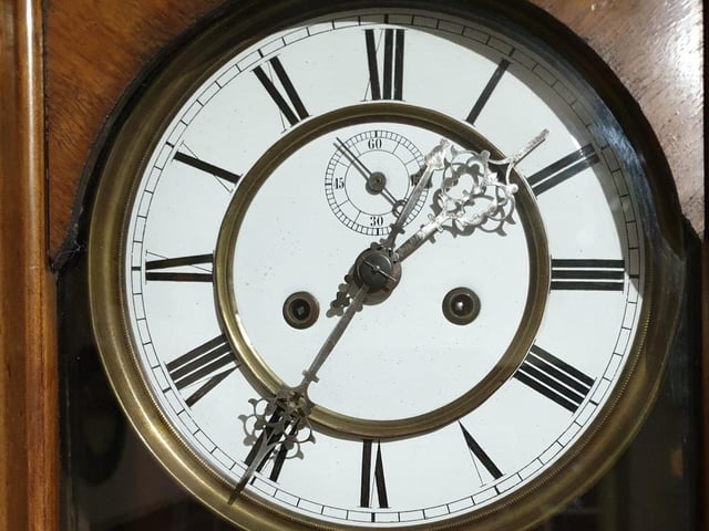 A close up of the clock's face.