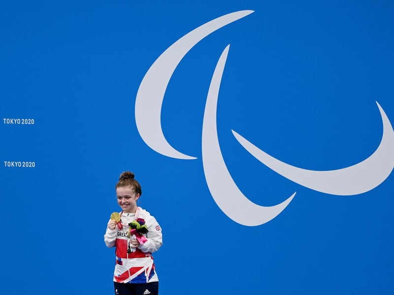 Maisie collects her medal at the Tokyo Paralympics