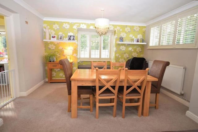 The dining room extends seamlessly from the lounge and features a bay window with fitted shutters and built-in seating. An attractive space, the room is perfect for family meals or for entertaining friends.