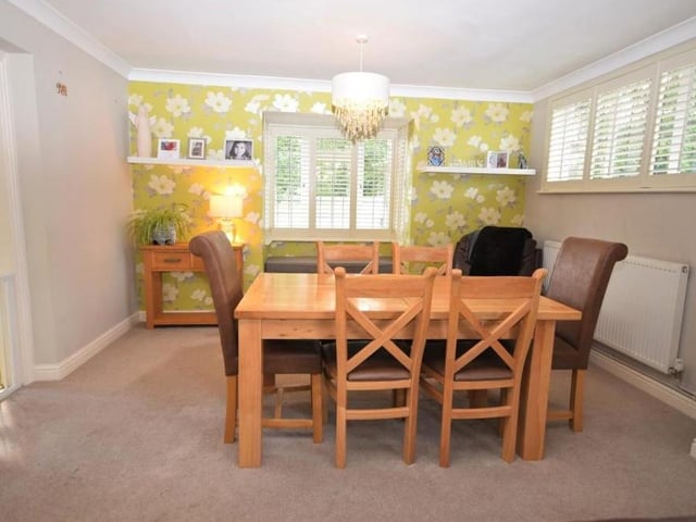 The dining room extends seamlessly from the lounge and features a bay window with fitted shutters and built-in seating. An attractive space, the room is perfect for family meals or for entertaining friends.