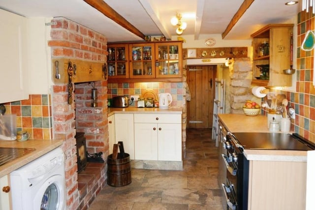 A third shot of the kitchen, which is both cute and rustic. It is fitted with a matching range of base and eye-level units, plus worktops and a stainless steel sink with single drainer and mixer tap. There is plumbing for an automatic washing machine and an electric point for a cooker.