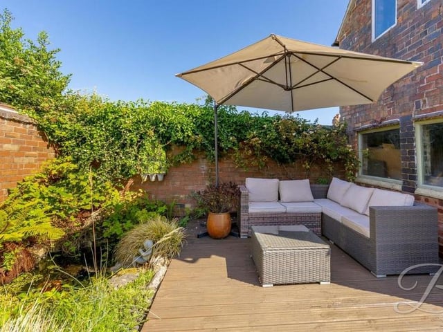 A decked seating area by the garden pond. It doesn't come much better than that.