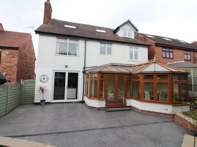 Let's conclude our photo gallery with a couple of exterior shots. This is how the Nottingham Road property looks from the rear, with the large conservatory jutting out on to a pressed concrete patio area.