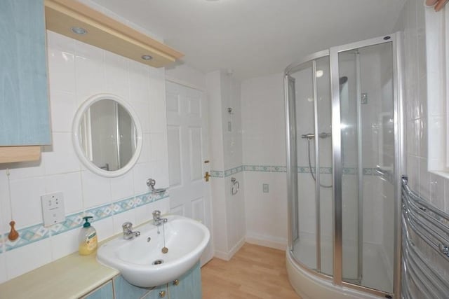 This striking shower room can also be found on the first floor of the £400,000 chalet bungalow. Fully tiled, it boasts a three-piece suite comprising a shower cubicle with Grohe shower, wash hand basin, low-level WC and vanity storage.