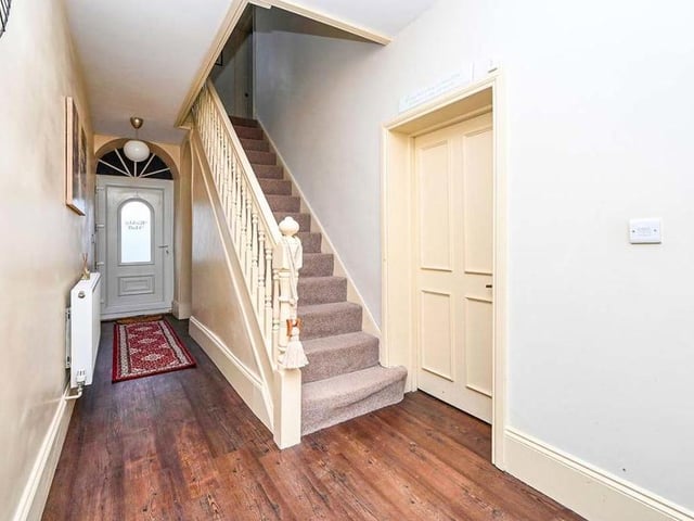 This is the entrance hallway, with the stairs leading to the first floor of the £370,000 Kirkby property. This hall also gives access to the cellar.