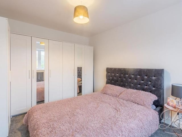 This attractive bedroom has plenty of space for wardrobes and storage.