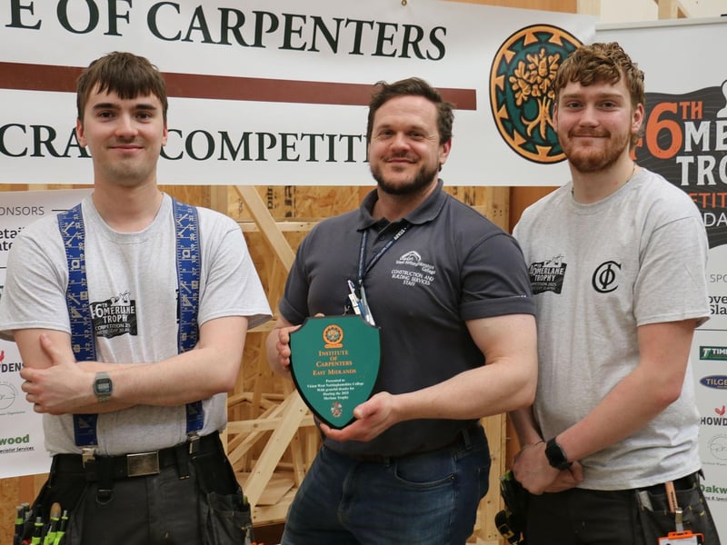 Sam, carpentry and joinery teacher Tim Dixon and Alfie with the trophy thanking the college for hosting the competitions