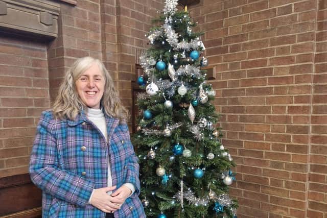 The Reverend Zoe Burton with a tree at the festival.