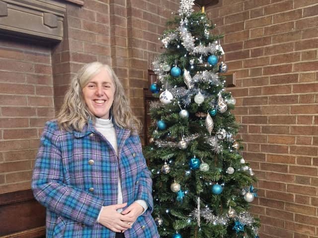 The Reverend Zoe Burton with a tree at the festival.